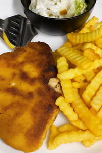 leckeres gebratenes Schnitzel mit Pommes, Zitrone und kleinen Salat
